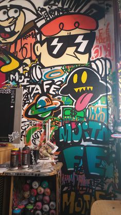 a room with graffiti on the wall and various items