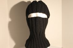 This ski mask is hand knit using acrylic yarn and comes from a smoke free home. It's a nice hat in black. With this ski mask you can cover all or none of your face.  Since it covers your neck there is no need for a scarf.  You can also fold it up to make a beanie.   It's great when you are outdoors in the cold for an extended period of time. Good for skiing, running, playing in the snow, walking to school, etc.  The ski mask will fit a head that measures about 16" to 20" around. And it measures 51/2" from top of hat to opening. Then 8" more to bottom.  I'd say it will fit a 4 year old on up.   Because of the ribbing it has some stretch to make it fit comfortably. It is easy care.  Machine wash and dry. Thanks for stopping by. Black Balaclava For Cold Weather, Black Full Face Balaclava One Size Fits Most, Black Balaclava For Skiing In Winter, Ski Mask With Ears, Black Balaclava For Winter, Black Skiing Balaclava For Winter, Black Balaclava For Winter, One Size Fits Most, Black Winter Balaclava, One Size Fits Most, Black Full Face Balaclava One Size