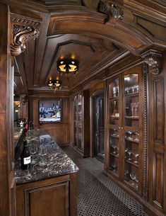 a wine cellar with marble counter tops and wood paneling on the walls is shown