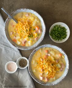 two bowls of soup with cheese and other toppings