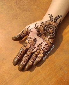 henna tattoo on the palm of a woman's hand