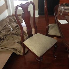 two wooden chairs sitting on top of a hard wood floor