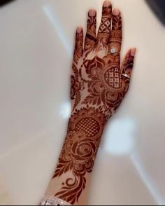 a woman's hand with henna on it