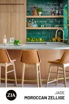 A wooden bar is met with tan leather stools as a green zellige backsplash showcases glassware and citrus fruits. Roof Tiles Design, Modern Mexican Hacienda, Tommy Bahama Kitchen, Zia Tile, Moroccan Architecture, Tiles Design, Roof Tiles, Kitchen Tile, Outdoor Kitchen Design