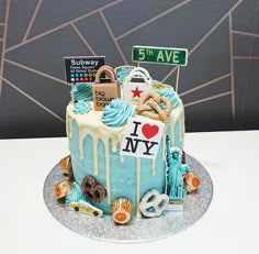 a birthday cake decorated with various items and the words i love new york on it