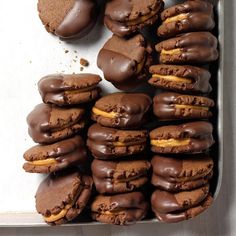 chocolate covered cookies with peanut butter on top are in a baking pan, ready to be eaten