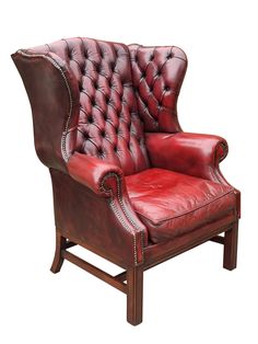 an old fashioned red leather chair with nailing on the armrests and back