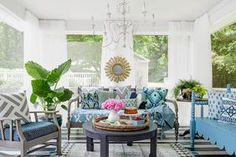 a living room filled with furniture and a chandelier