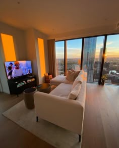 a living room filled with furniture and a flat screen tv mounted to the side of a wall