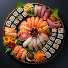 an assortment of sushi on a plate with sauce and garnishes in the middle