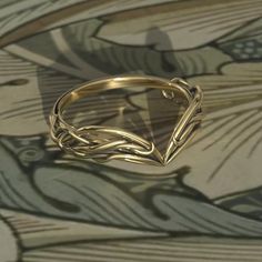 a gold ring sitting on top of a table