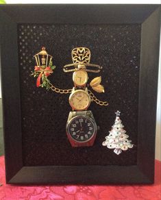 a clock and christmas tree are in a shadow box