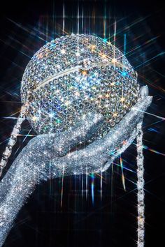 a close up of a person's hand holding an object with sparkling lights on it