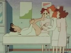 three women standing around a woman laying on a bed