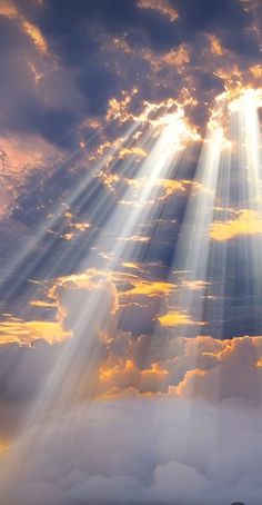 the sun is shining through clouds with bright beams in the sky above it and below