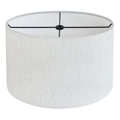 a white lampshade with black trim around the bottom and an inner light fixture