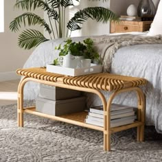 a wicker coffee table sitting on top of a carpeted floor next to a bed