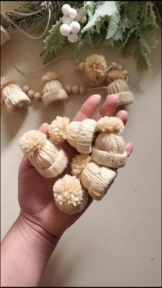 a hand is holding some small white flowers