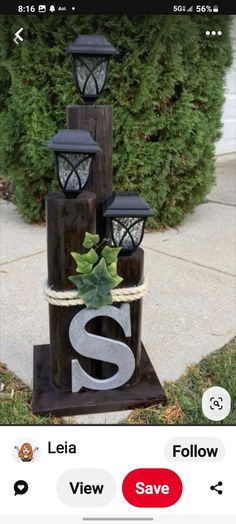 a wooden sign that has some lights on top of it and the letter s in front of it