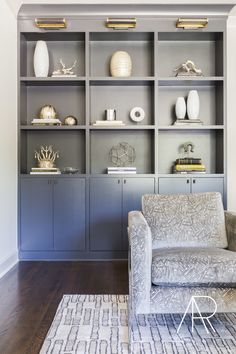 a living room filled with furniture and lots of shelves