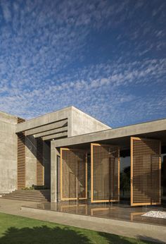 an exterior view of a concrete building with wooden slats