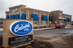 the exterior of a store with blue awnings