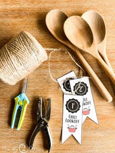 wooden spoons, yarn and scissors on a table