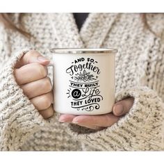 a woman holding a white coffee mug with the words and so together they must be loved