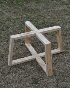 a wooden structure sitting on top of a grass covered field