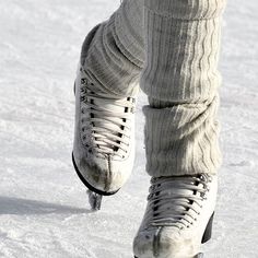 the legs and feet of a person wearing ice skates