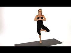 a woman is doing yoga on a mat