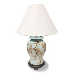 a lamp that is sitting on top of a white surface with a blue and gold design