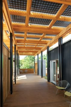 the inside of a building with glass doors and wood slats on the outside wall