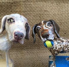 two dog figurines sitting next to each other