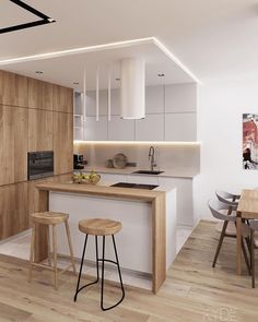 a kitchen with an island and stools in it