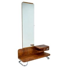 a wooden table with a mirror and shelf on it's side, against a white background