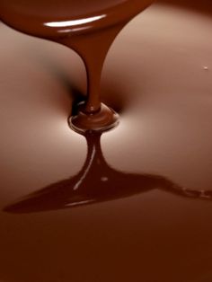 melted chocolate is being poured onto the surface