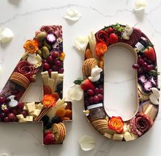 the number forty four made out of fruits and vegetables is displayed on a marble surface