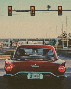 an old car is stopped at a red light