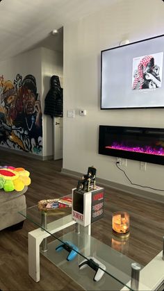 a living room filled with furniture and a flat screen tv mounted on the wall over a fire place