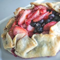 a close up of a pie with fruit on it