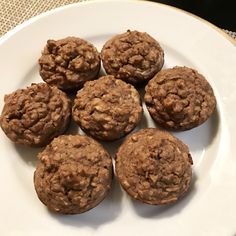 a white plate topped with chocolate muffins on top of a table