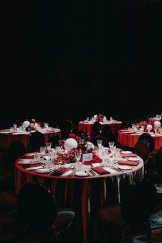 the tables are set with red and white linens for an elegant dinnereon party