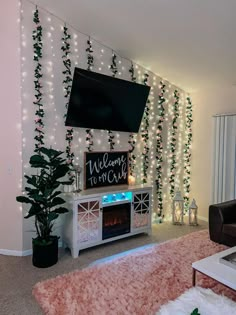 a living room decorated for christmas with lights on the wall and a flat screen tv