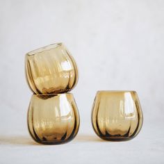 two yellow vases sitting on top of each other