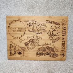 a wooden cutting board with writing on it and some food around the edges that says something to eat, something to die, something to do, something