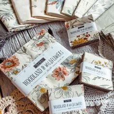 the wooden table is covered with napkins and crocheted doily, which are laid out on top of each other