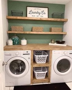 a washer and dryer in a laundry room with shelves above them, on the wall