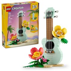 a toy ukulele with flowers in it and a box