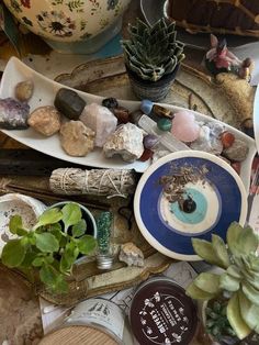 a table topped with plates and bowls filled with rocks